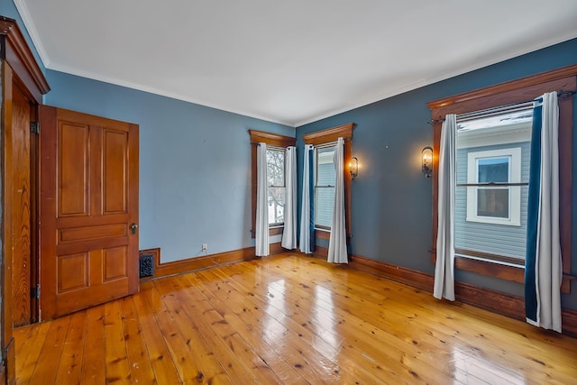 unfurnished bedroom with light hardwood / wood-style floors and ornamental molding