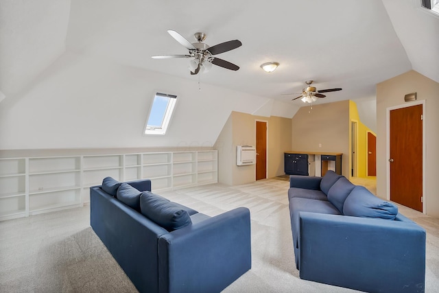 living room with heating unit, light colored carpet, lofted ceiling with skylight, and ceiling fan