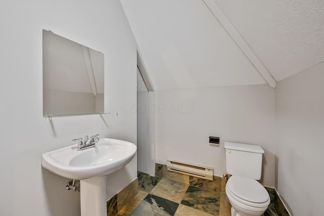 bathroom featuring a textured ceiling, a baseboard heating unit, sink, toilet, and lofted ceiling