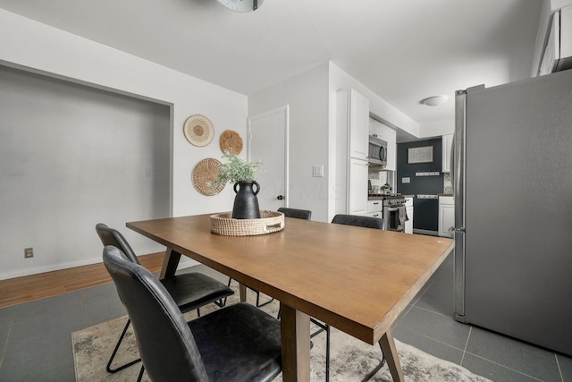 dining area with dark tile patterned flooring