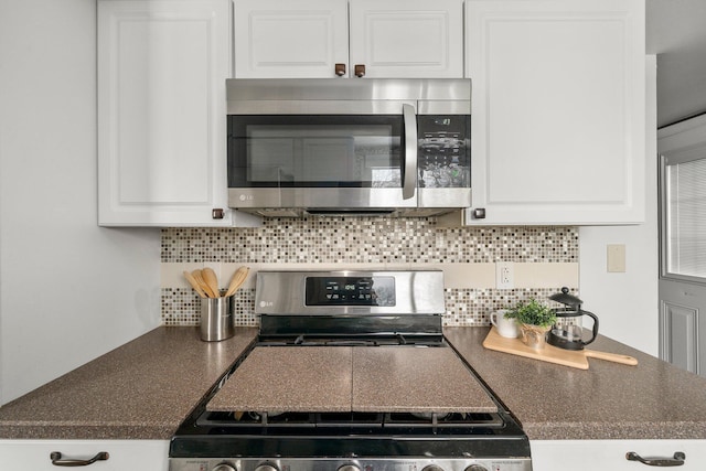 kitchen with stainless steel appliances, white cabinetry, and tasteful backsplash