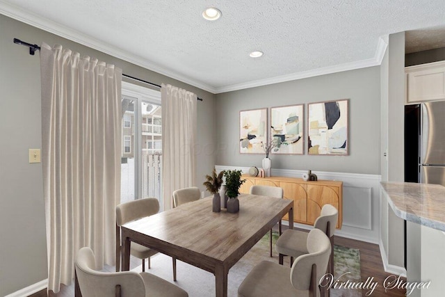 dining area with hardwood / wood-style floors, crown molding, and a textured ceiling