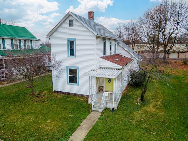 back of house with a lawn