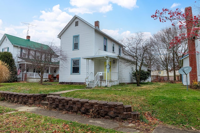 back of house with a lawn