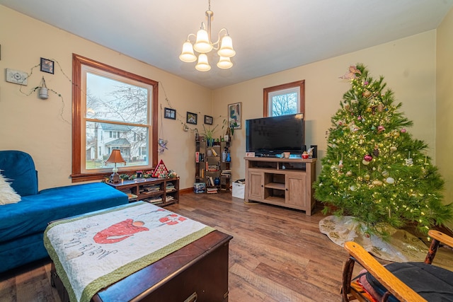 bedroom featuring hardwood / wood-style floors and an inviting chandelier