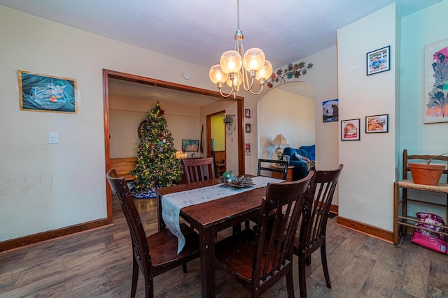 dining area featuring dark hardwood / wood-style floors and a chandelier