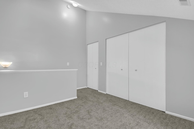 unfurnished bedroom featuring carpet and high vaulted ceiling