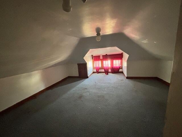 additional living space with lofted ceiling and carpet flooring