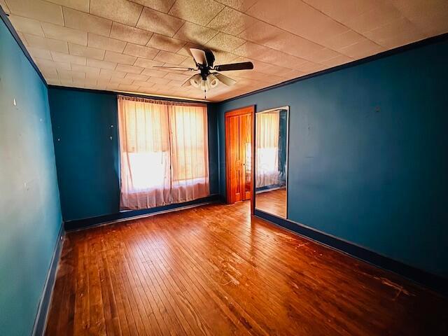 empty room featuring hardwood / wood-style floors and ceiling fan