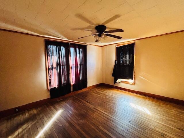 unfurnished room featuring hardwood / wood-style flooring, crown molding, and ceiling fan