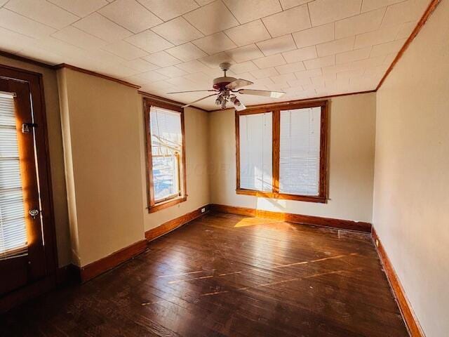 spare room with ceiling fan, ornamental molding, and dark hardwood / wood-style flooring