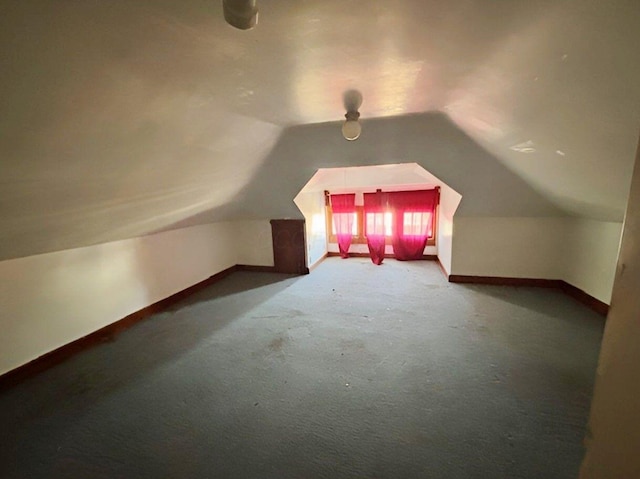 bonus room featuring lofted ceiling, baseboards, and carpet floors