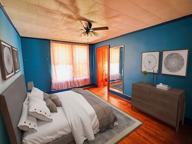 bedroom featuring a ceiling fan and wood finished floors