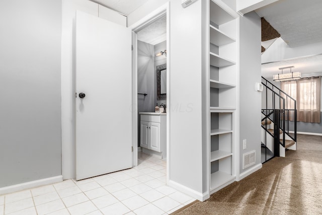 corridor featuring light tile patterned floors