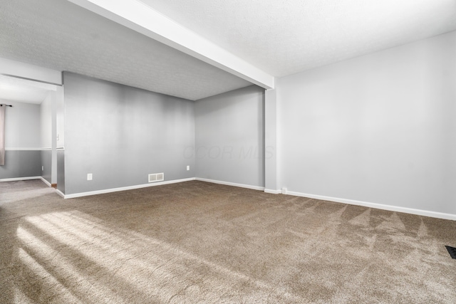 basement featuring carpet flooring and a textured ceiling