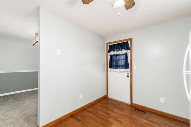 spare room featuring ceiling fan and wood-type flooring