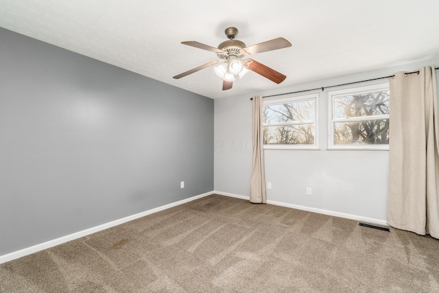 carpeted empty room with ceiling fan