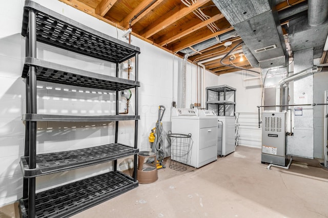 basement featuring separate washer and dryer and heating unit