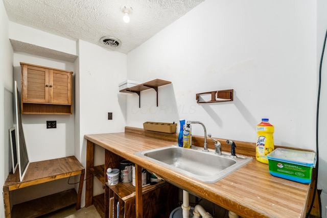 kitchen with a textured ceiling and sink