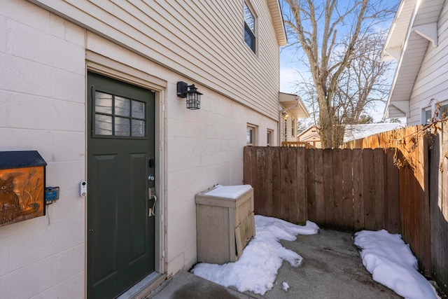 view of snow covered property entrance