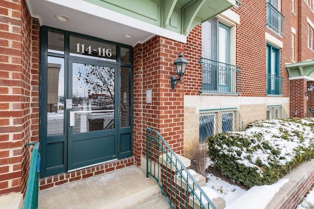 view of snow covered property entrance