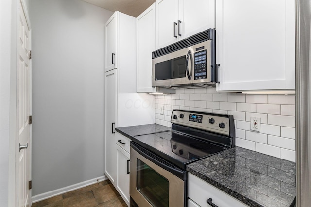 kitchen with white cabinets, decorative backsplash, and appliances with stainless steel finishes