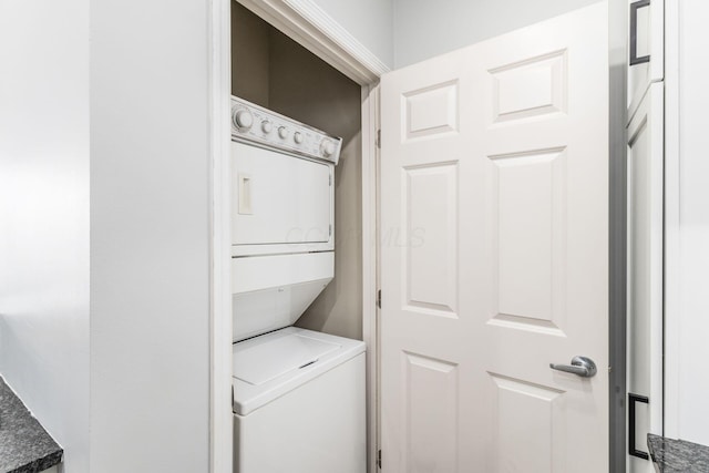 laundry room with stacked washing maching and dryer