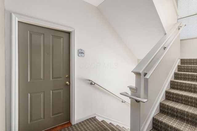 staircase featuring vaulted ceiling