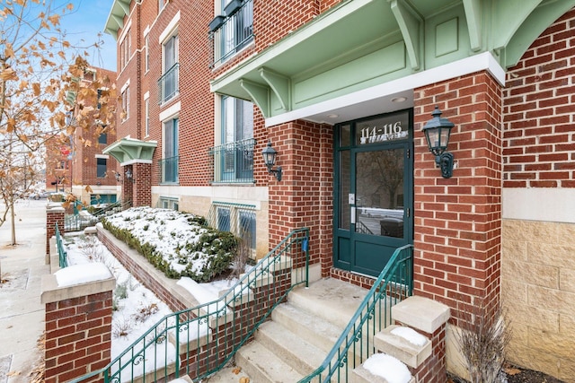 view of snow covered property entrance