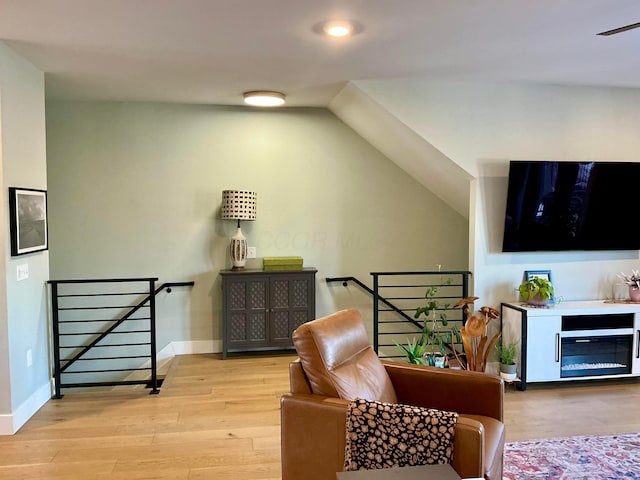 sitting room with lofted ceiling and light hardwood / wood-style flooring