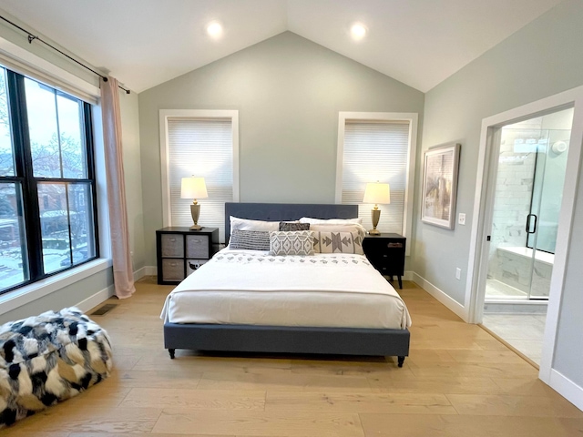 bedroom with lofted ceiling, light wood-type flooring, and multiple windows