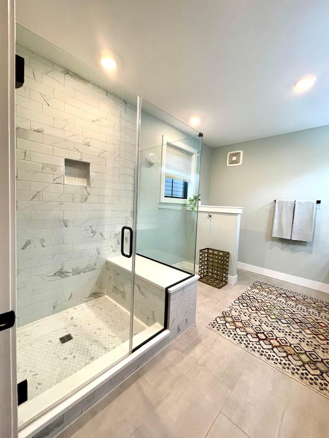 bathroom featuring walk in shower and tile patterned flooring