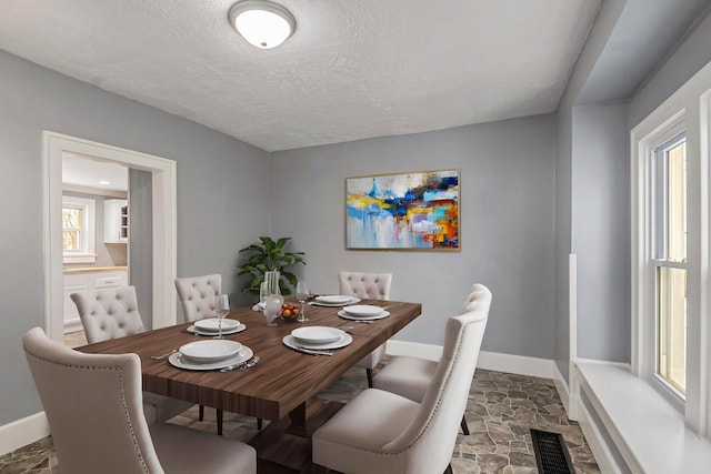 dining area with a textured ceiling