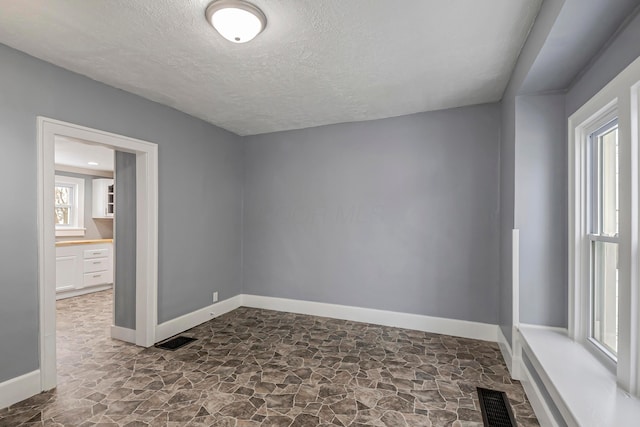 empty room featuring a textured ceiling