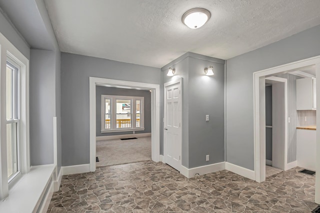 hallway featuring a textured ceiling