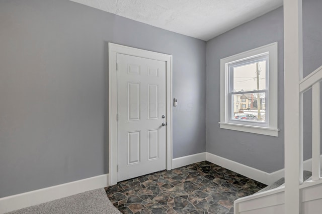 entryway with a textured ceiling