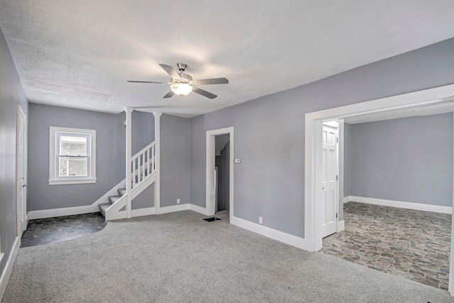 carpeted spare room with ceiling fan