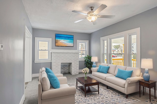 living room with ceiling fan, light colored carpet, a wealth of natural light, and a brick fireplace