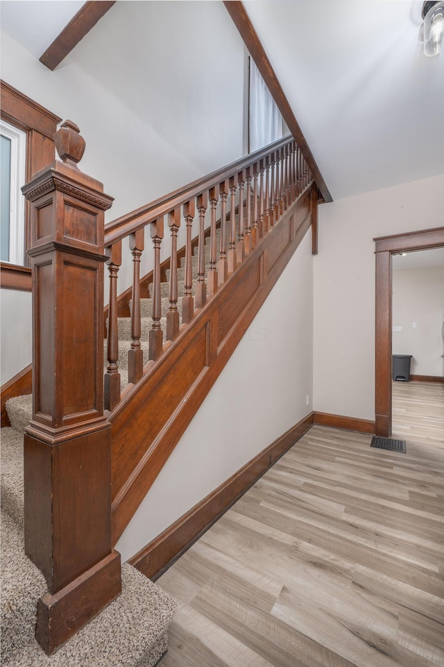 stairs featuring hardwood / wood-style flooring