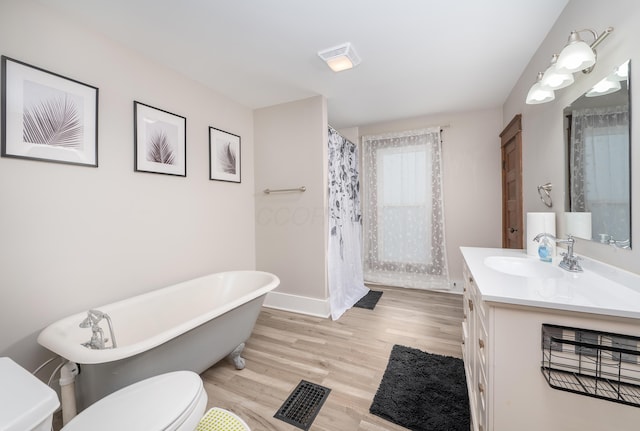 full bathroom featuring toilet, separate shower and tub, hardwood / wood-style flooring, and vanity