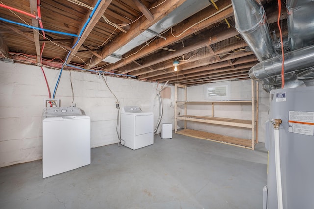 basement with washing machine and clothes dryer and electric water heater