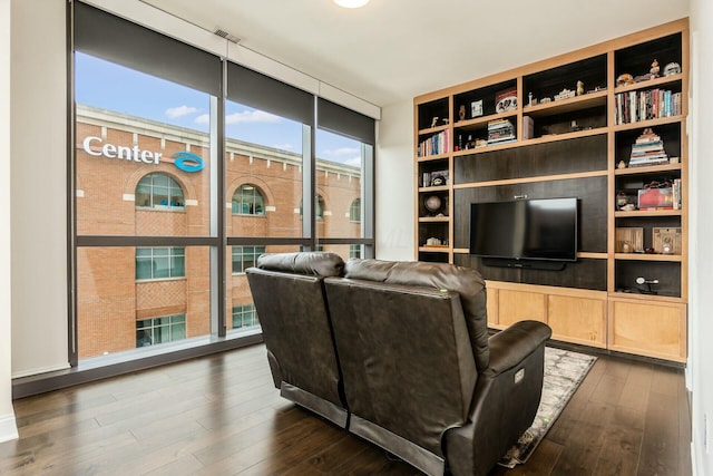 living room with expansive windows and dark hardwood / wood-style flooring