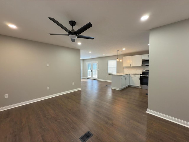 unfurnished living room with dark hardwood / wood-style floors, ceiling fan, and french doors