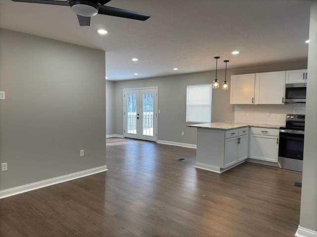 kitchen featuring white cabinets, stainless steel appliances, kitchen peninsula, and decorative backsplash