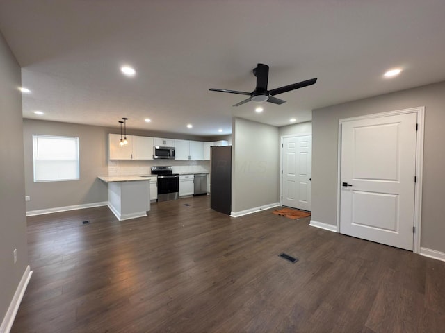 unfurnished living room with dark hardwood / wood-style floors and ceiling fan