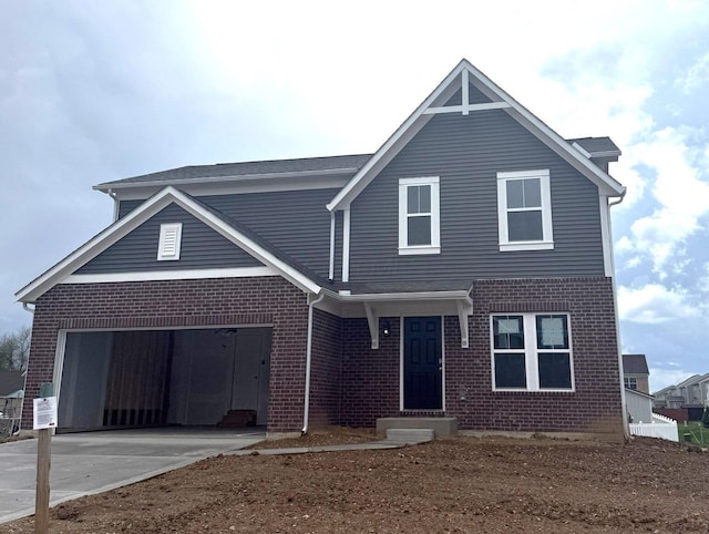 view of front facade with a garage, entry steps, driveway, and brick siding