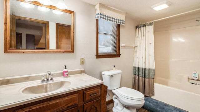 bathroom with toilet, shower / bath combo with shower curtain, and vanity