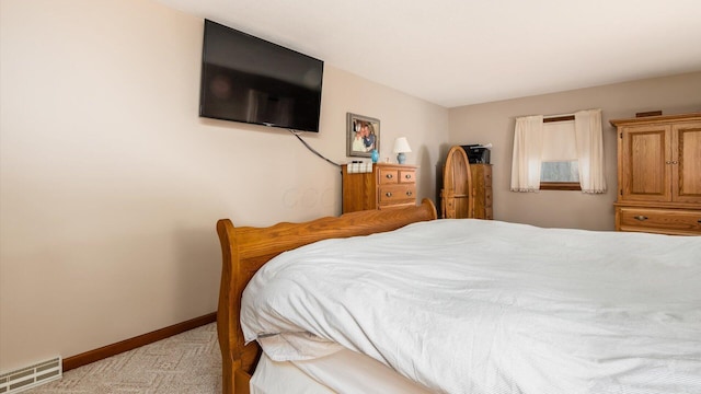 bedroom with light colored carpet, visible vents, and baseboards