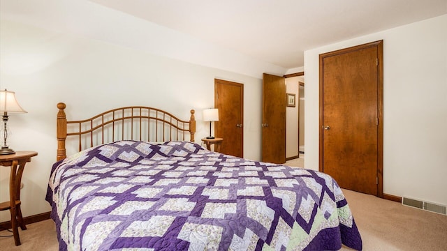 bedroom featuring carpet floors, visible vents, and baseboards