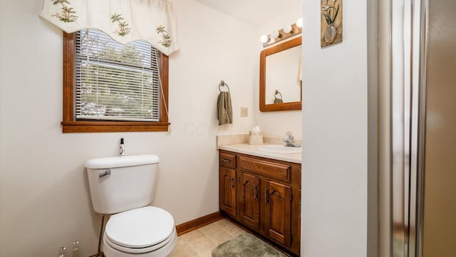 bathroom with tile patterned floors, vanity, toilet, and baseboards